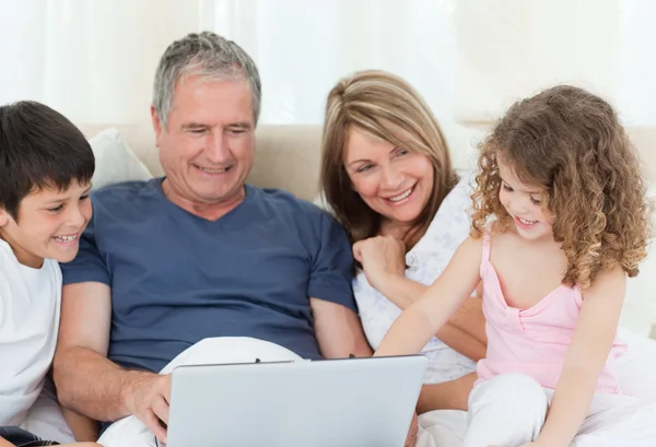 Familie kijken naar hun laptop — Stockfoto