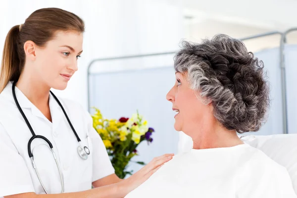 Mature woman talking with her nurse — Stock Photo, Image