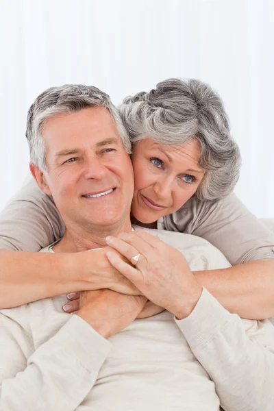 Mature woman hugging her husband — Stock Photo, Image