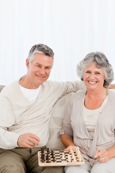 Senior couple looking at the camera at home — Stock Photo, Image
