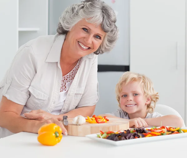 Boy and his grandmother looking at the camera — Stock Photo, Image