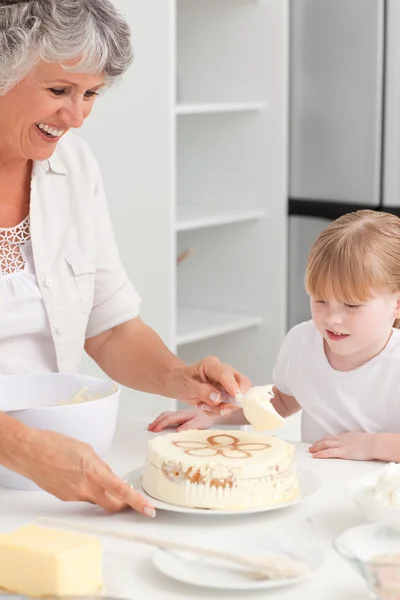 Girl baking with her grandmother at home — Stock Photo, Image