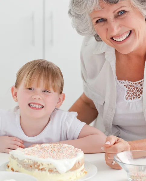 Lovely girl and her grandmother looking at the camera — Stock Photo, Image