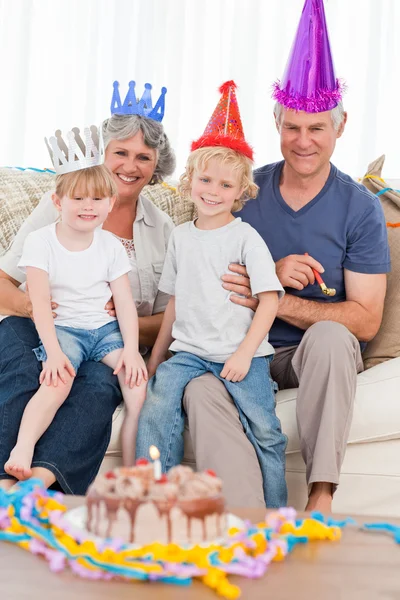 Happy family looking at the camera on a birthday — Stock Photo, Image