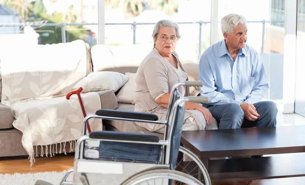 Lovely retired couple talking on the sofa — Stock Photo, Image