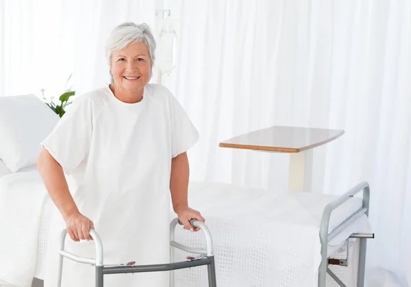 Senior woman looking at the camera with her zimmer frame — Stock Photo, Image