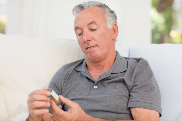 Senior with pills at home — Stock Photo, Image