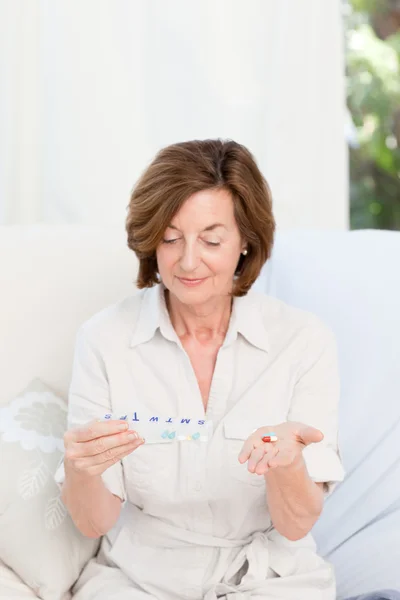 Cute mature woman with pills — Stock Photo, Image