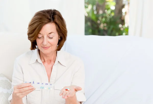 Cute mature woman with pills — Stock Photo, Image
