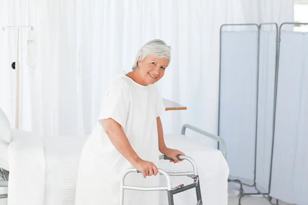 Senior woman looking at the camera with her zimmer frame — Stock Photo, Image