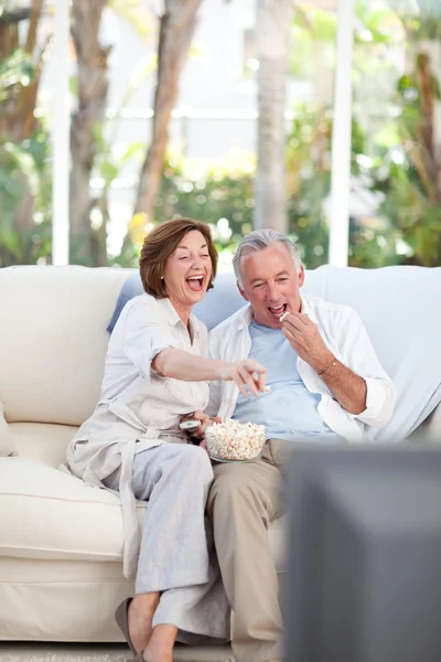 Пенсионеры смотрят телевизор дома — стоковое фото