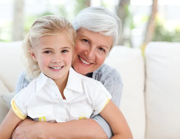 Lovely little girl with her grandmother looking at the camera — Stock Photo, Image