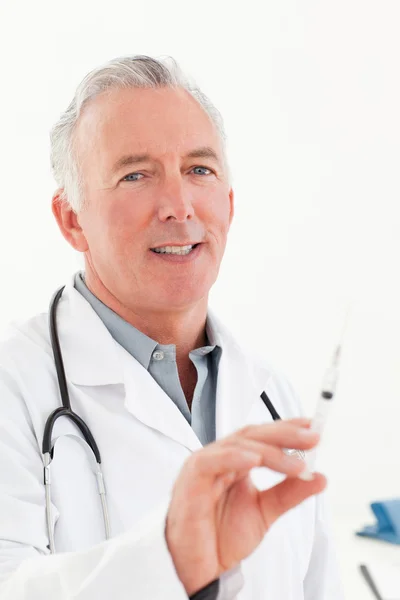 Senior doctor with syringes — Stock Photo, Image