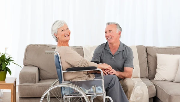 Man with his wife in a wheelchair — Stock Photo, Image