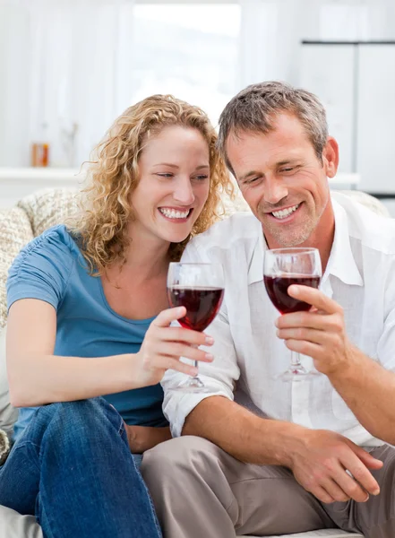 Coppia che beve del vino rosso in salotto — Foto Stock