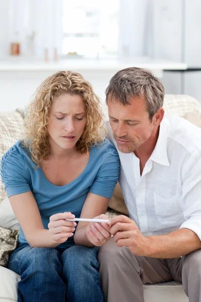 Lovers looking at a pregnancy test — Stock Photo, Image