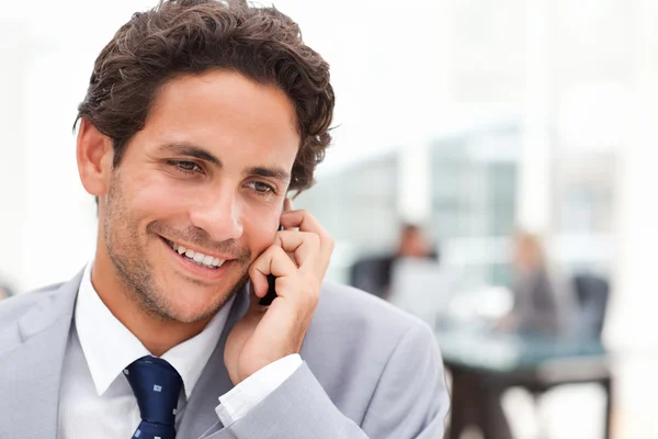 Charming businessman phoning in his office — Stock Photo, Image
