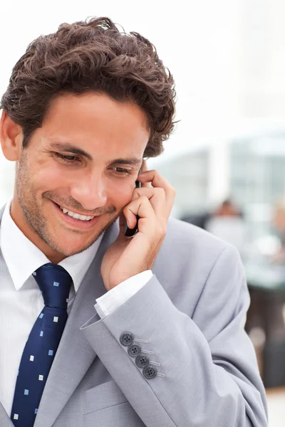 Charming businessman phoning in his office — Stock Photo, Image