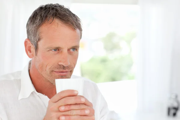 Handsome man smelling his coffee — Stock Photo, Image