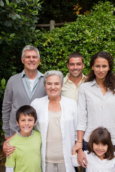 Family looking at the camera in the garden — Stock Photo, Image