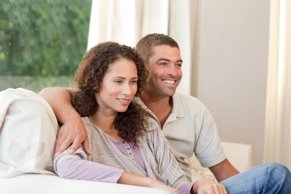 Пара смотрит телевизор в своей гостиной на дому — стоковое фото