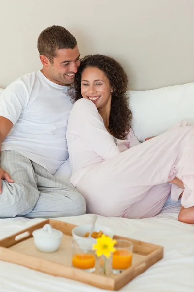 Couple having breakfast in their bed at home — Stock Photo, Image