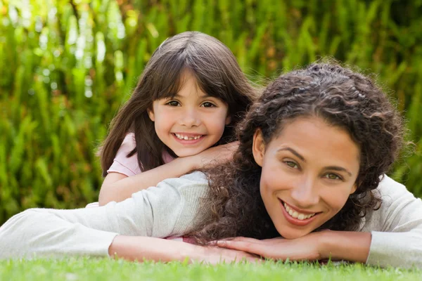 Adorable mother with her daughter in the garden — Stock Photo, Image