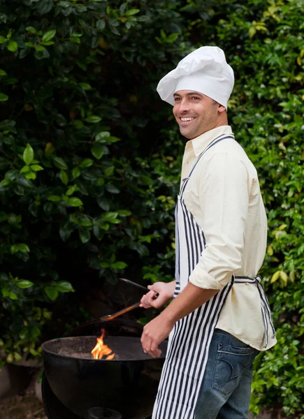 stock image Man having a barbecue in the garden