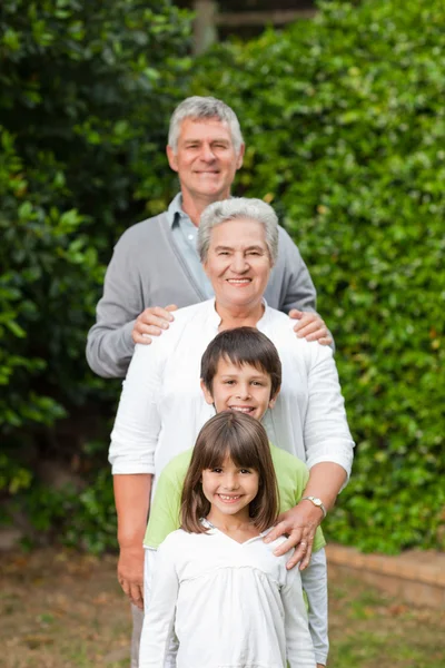 Grandparents with their children looking at the camera in the ga — Stock Photo, Image