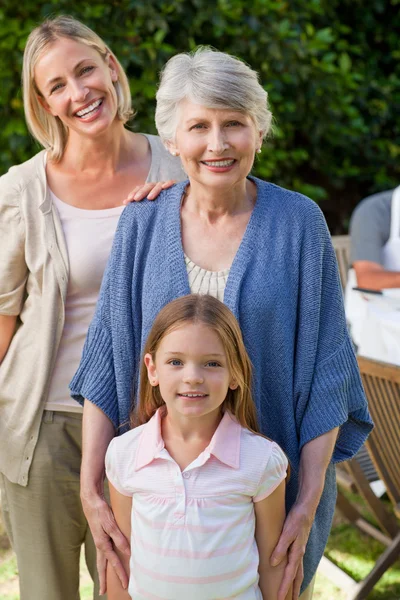 Family looking at the camera in the garden — Stock Photo, Image