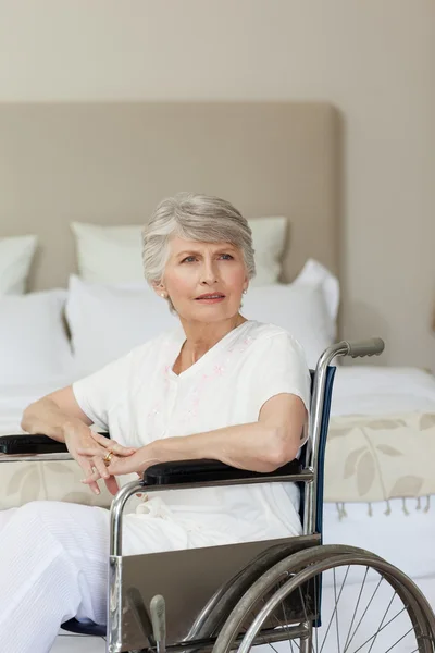 Konzentrierte Seniorin im Rollstuhl zu Hause — Stockfoto
