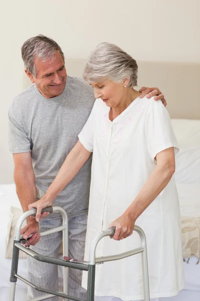 Man helping his wife to walk — Stock Photo, Image
