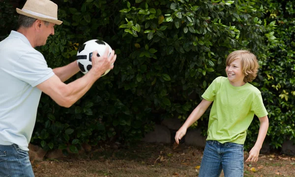 Grandfather and his grandson playing football — Stock Photo, Image