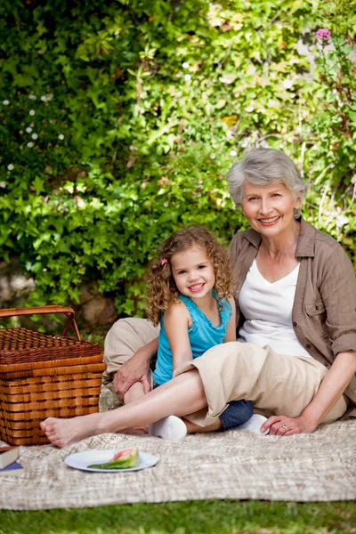 Grootmoeder met haar kleindochter in de tuin — Stockfoto