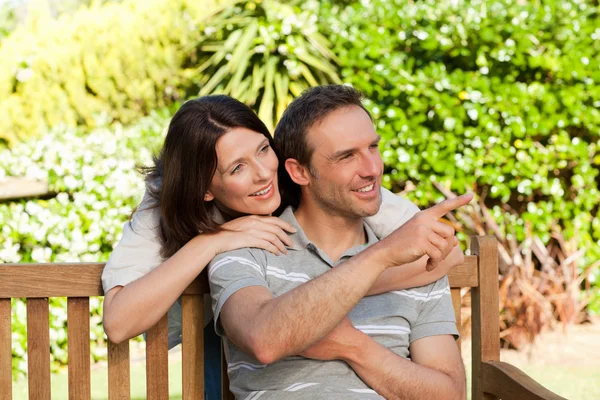 Glad couple hugging in the garden — Stock Photo, Image