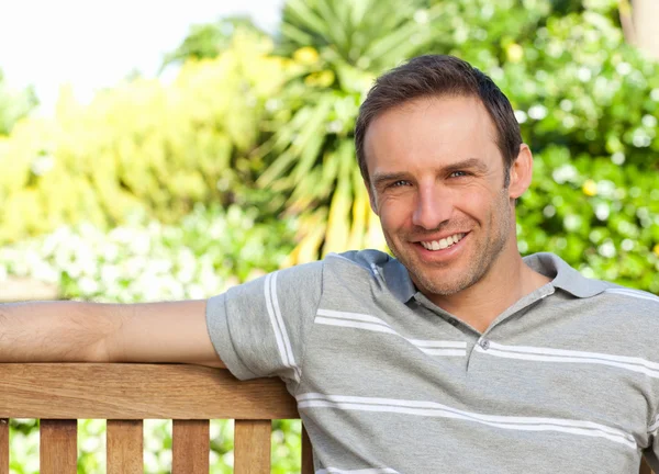 Portrait of a man sitting on a bench — Stock Photo, Image