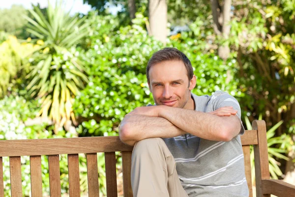 Portrait of a man sitting on a bench — Stock Photo, Image