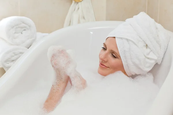 Милая женщина принимает ванну с полотенцем на голове — стоковое фото