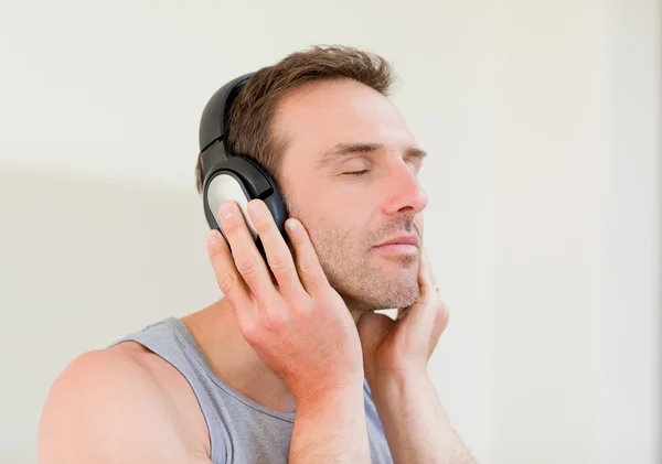 Hombre guapo escuchando algo de música — Foto de Stock