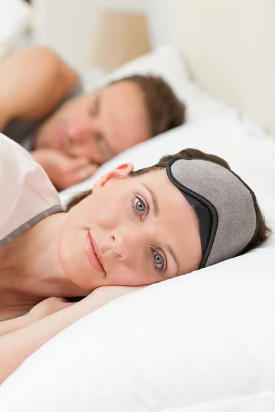 Lovely couple lying down in their bed — Stockfoto