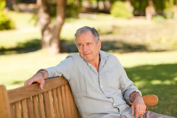 Senior man sitting on a bench — Stock Photo, Image