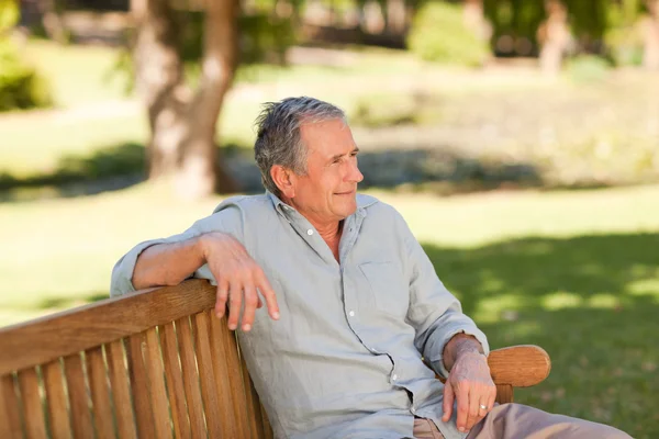 Homme âgé assis sur un banc — Photo