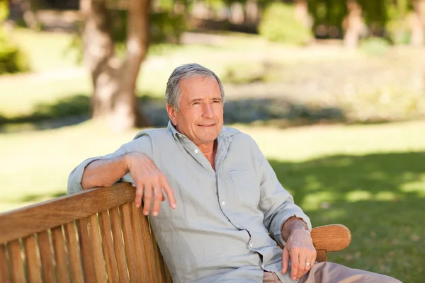 Senior man sitting on a bench — Stock Photo, Image
