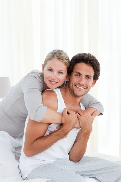 Lovely couple hugging on their bed Stock Photo
