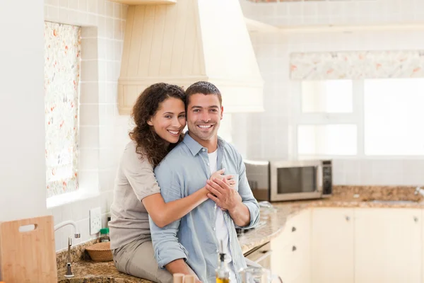 Beautiful couple hugging in the kitchen Stock Picture