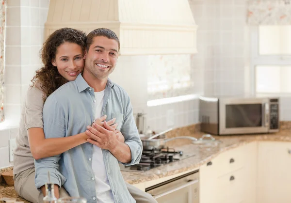Beautiful couple hugging in the kitchen Stock Image