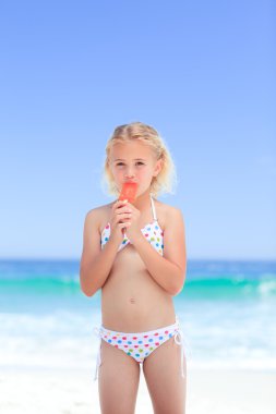 Little girl eating her ice cream clipart
