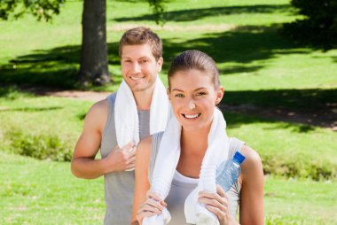 Sporty couple in the park clipart