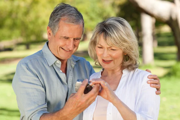 Mature couple looking at their camera — Stock Photo, Image