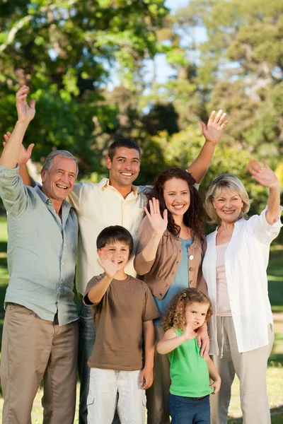 Family looking at the camera in the park — Stock Photo, Image